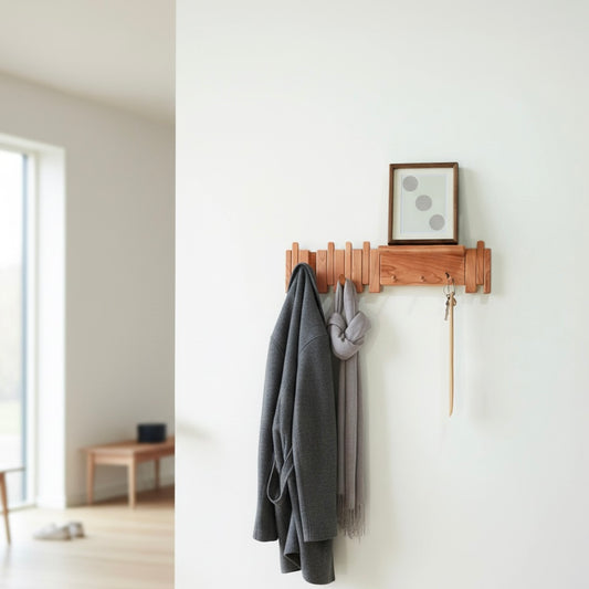 Wall-mounted solid wood coat rack with piano key–style foldable hooks for entryway and hallway organization